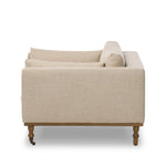 With traditional details like turned oak legs and brass casters, this low-profile accent chair features an elongated bench seat for an inviting sit. Performance fabric in neutral wheat finishes a knife-edge back and boxed arm cushions Amethyst Home provides interior design, new home construction design consulting, vintage area rugs, and lighting in the Nashville metro area.