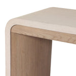 A thick layer of beige painted linen cascades this desk's soft waterfall shape in an eye-catching combination of texture. Crafted atop a mahogany and oak veneer base with rounded corners, this hardworking piece elevates the home-office workspace Amethyst Home provides interior design, new home construction design consulting, vintage area rugs, and lighting in the Laguna Beach metro area.