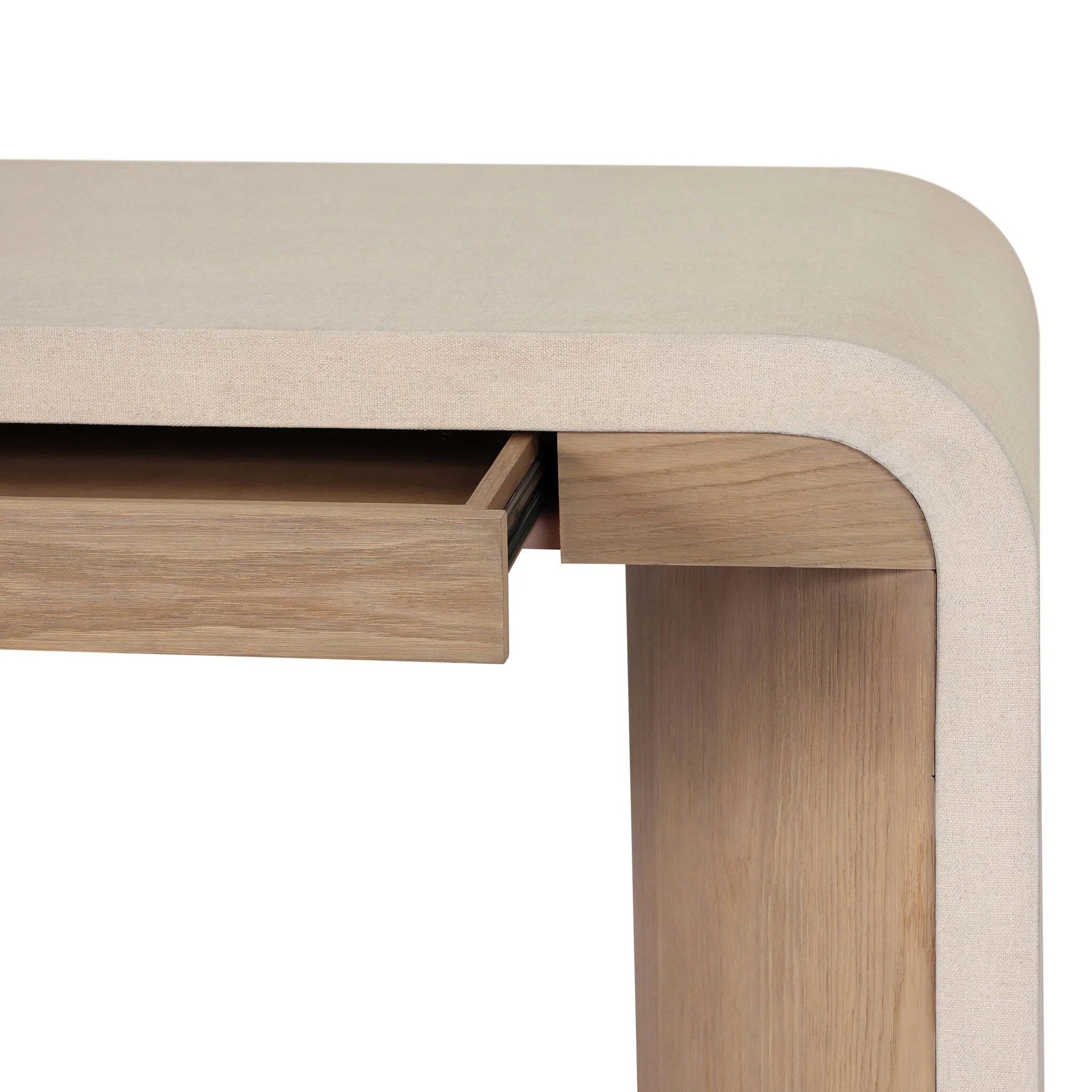 A thick layer of beige painted linen cascades this desk's soft waterfall shape in an eye-catching combination of texture. Crafted atop a mahogany and oak veneer base with rounded corners, this hardworking piece elevates the home-office workspace Amethyst Home provides interior design, new home construction design consulting, vintage area rugs, and lighting in the Monterey metro area.