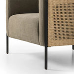 On-trend and expertly tailored, a texture-driven chair is upholstered in an olive flax/linen blend and wrapped with natural rattan, with linear iron legs finished in a complementary gunmetal Amethyst Home provides interior design, new home construction design consulting, vintage area rugs, and lighting in the Austin metro area.