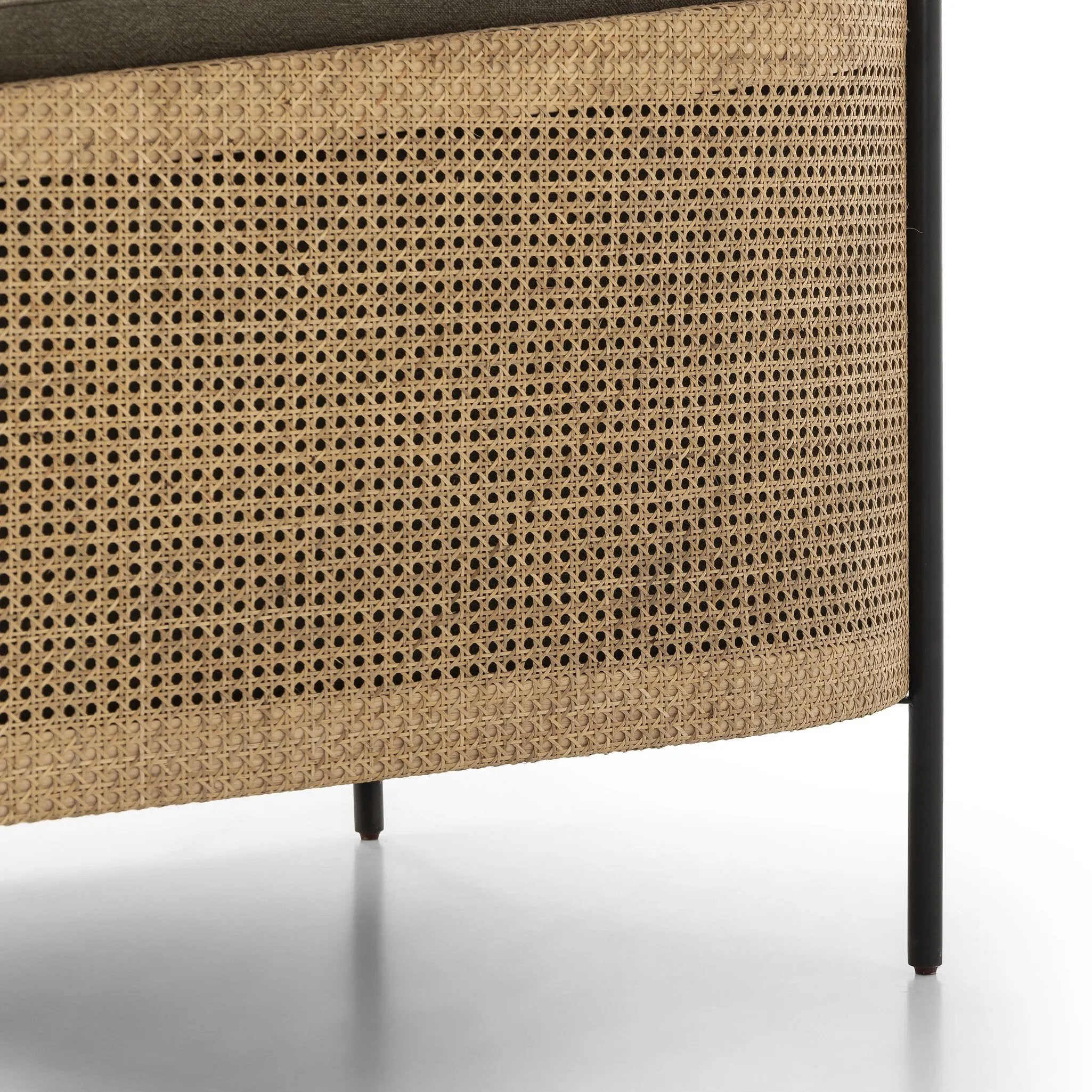 On-trend and expertly tailored, a texture-driven chair is upholstered in an olive flax/linen blend and wrapped with natural rattan, with linear iron legs finished in a complementary gunmetal Amethyst Home provides interior design, new home construction design consulting, vintage area rugs, and lighting in the Portland metro area.