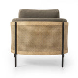 On-trend and expertly tailored, a texture-driven chair is upholstered in an olive flax/linen blend and wrapped with natural rattan, with linear iron legs finished in a complementary gunmetal Amethyst Home provides interior design, new home construction design consulting, vintage area rugs, and lighting in the Seattle metro area.