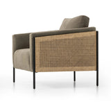 On-trend and expertly tailored, a texture-driven chair is upholstered in an olive flax/linen blend and wrapped with natural rattan, with linear iron legs finished in a complementary gunmetal Amethyst Home provides interior design, new home construction design consulting, vintage area rugs, and lighting in the Washington metro area.