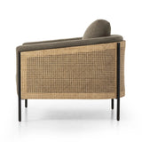 On-trend and expertly tailored, a texture-driven chair is upholstered in an olive flax/linen blend and wrapped with natural rattan, with linear iron legs finished in a complementary gunmetal Amethyst Home provides interior design, new home construction design consulting, vintage area rugs, and lighting in the Winter Garden metro area.