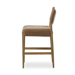 A fresh take on midcentury styling, perfectly sized for the counter. Supportive back and seat cushions are upholstered in a soft, neutral fabric and framed out by toasted solid oak Amethyst Home provides interior design, new home construction design consulting, vintage area rugs, and lighting in the Calabasas metro area.