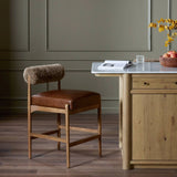 Featuring Jazelle Taupe Shearling Counter Stool by Four Hands at Amethyst Home. Bring mixed materials to the counter. Solid oak, top-grain leather and soft shearling fuse for a playful update to midcentury and Seventies styling. Overall Dimensions: 22.25"w x 25.75"d x 36.50"h. Amethyst Home provides interior design, new home construction design consulting, vintage area rugs, and lighting in the Houston metro area.