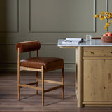 Featuring Jazelle Altair Sienna Counter Stool by Four Hands at Amethyst Home. The classic counter stool gets a playful update with a bolstered cylinder seat back. Made from top-grain leather and warm-finished oak to elevate your bar, kitchen or dining space. Overall Dimensions: 22.25"w x 25.75"d x 36.50"h. Amethyst Home provides interior design, new home construction design consulting, vintage area rugs, and lighting in the Miami metro area.