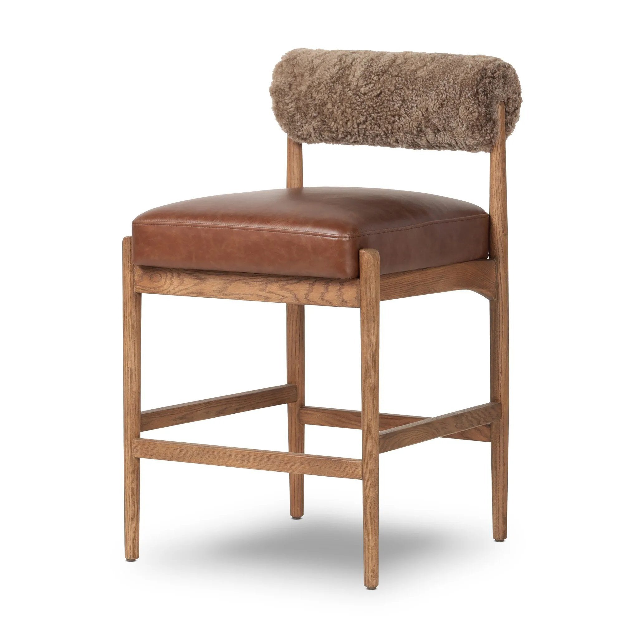 Featuring Jazelle Taupe Shearling Counter Stool by Four Hands at Amethyst Home. Bring mixed materials to the counter. Solid oak, top-grain leather and soft shearling fuse for a playful update to midcentury and Seventies styling. Overall Dimensions: 22.25"w x 25.75"d x 36.50"h. Amethyst Home provides interior design, new home construction design consulting, vintage area rugs, and lighting in the Miami metro area.