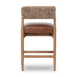 Featuring Jazelle Taupe Shearling Counter Stool by Four Hands at Amethyst Home. Bring mixed materials to the counter. Solid oak, top-grain leather and soft shearling fuse for a playful update to midcentury and Seventies styling. Overall Dimensions: 22.25"w x 25.75"d x 36.50"h. Amethyst Home provides interior design, new home construction design consulting, vintage area rugs, and lighting in the Nashville metro area.