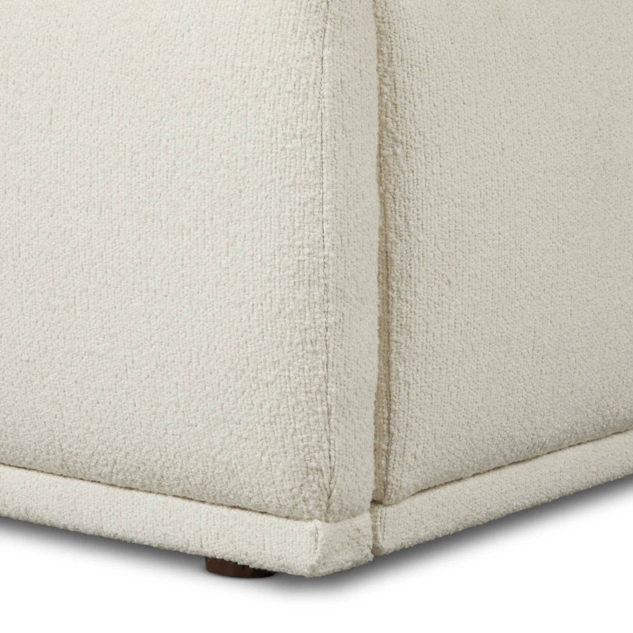 Swooping curves and full upholstery make for an elegant combination. Cream fabric wraps generous cushioning all around, giving textural depth to the bed Amethyst Home provides interior design, new home construction design consulting, vintage area rugs, and lighting in the Calabasas metro area.