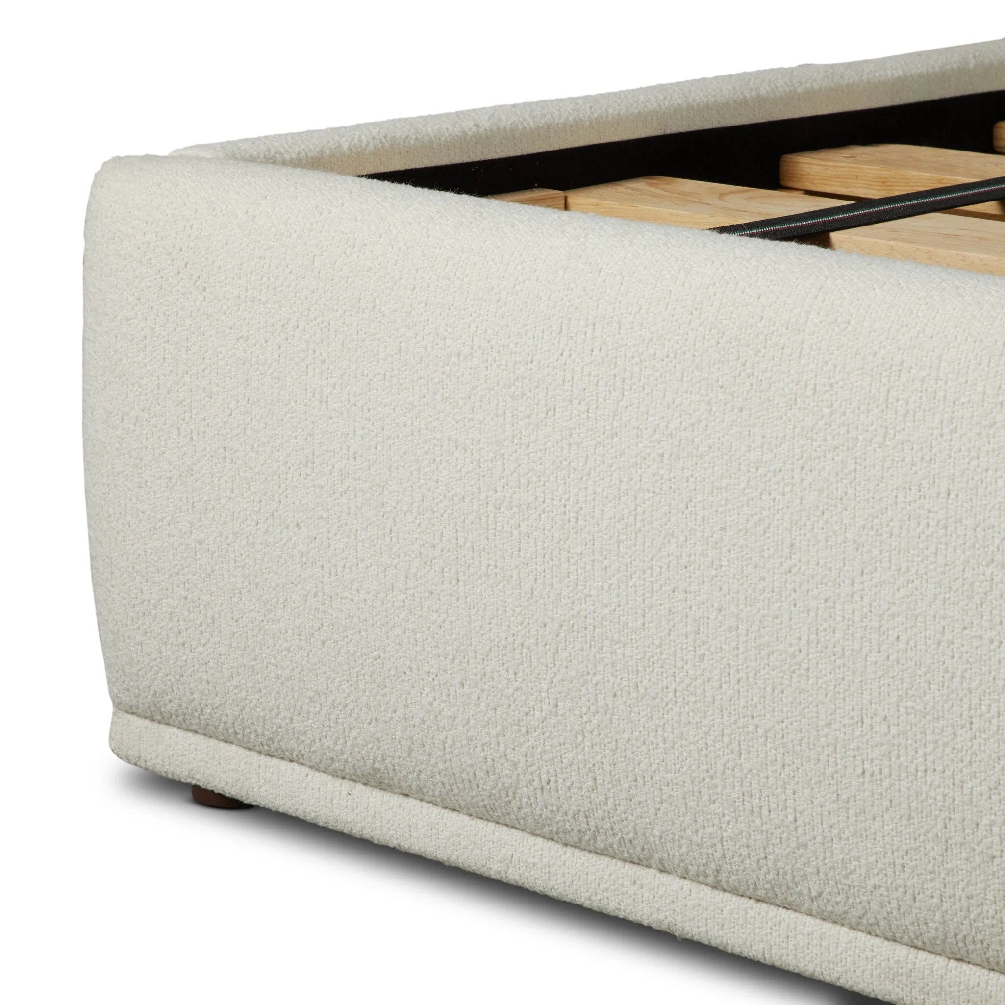 Swooping curves and full upholstery make for an elegant combination. Cream fabric wraps generous cushioning all around, giving textural depth to the bed Amethyst Home provides interior design, new home construction design consulting, vintage area rugs, and lighting in the Houston metro area.