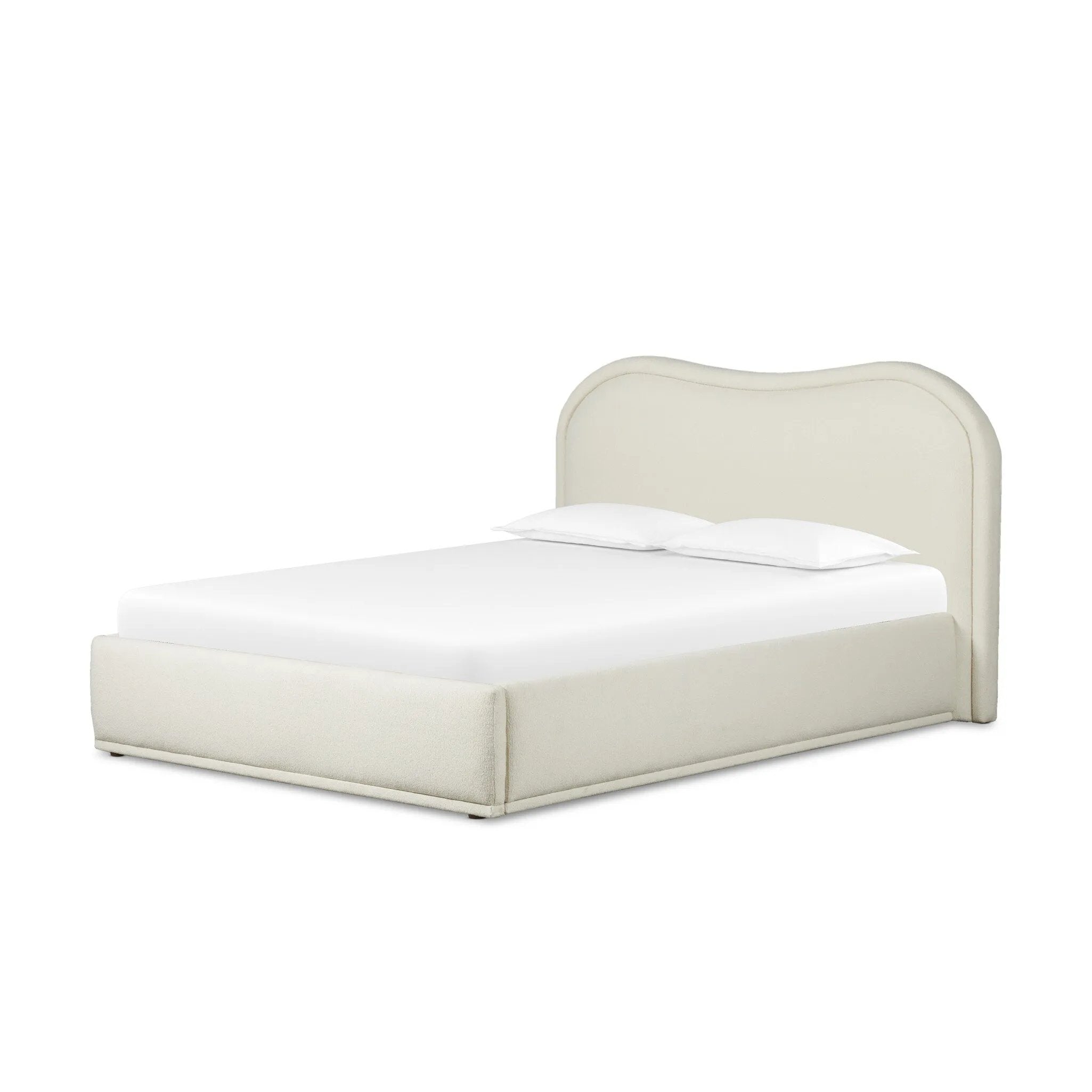 Swooping curves and full upholstery make for an elegant combination. Cream fabric wraps generous cushioning all around, giving textural depth to the bed Amethyst Home provides interior design, new home construction design consulting, vintage area rugs, and lighting in the Monterey metro area.