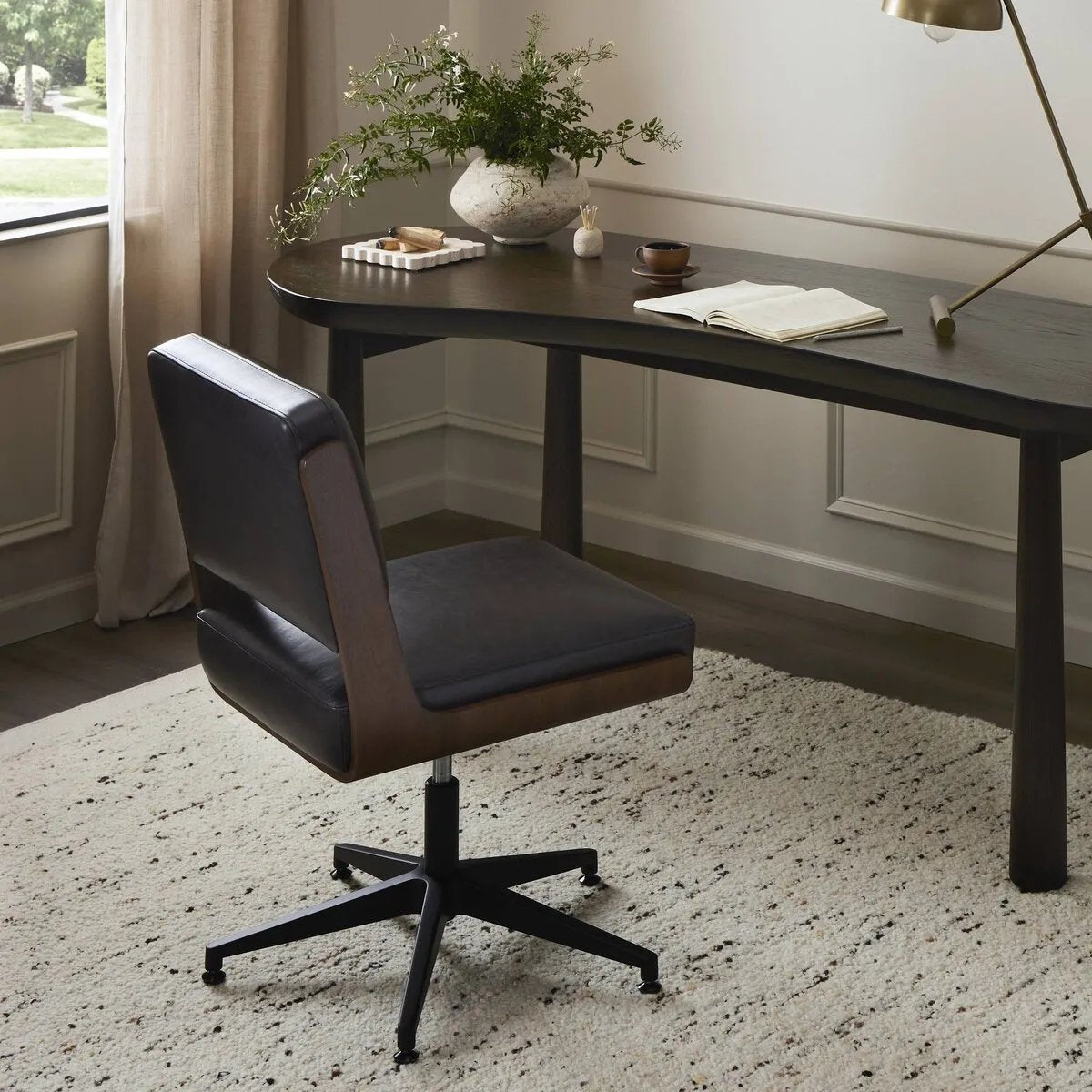 Featuring Landon Sonoma Black Armless Desk Chair by Four Hands at Amethyst Home. A nod to midcentury design, a molded wood frame veneered in rich walnut is paired with black top-grain leather cushions for maximum comfort. Height adjustable and 360-degree swivel function for ease in the workplace.
Overall Dimensions: 26.75" L x 20.5 " W x 34.0" H
Materials: . Amethyst Home provides interior design, new home construction design consulting, vintage area rugs, and lighting in the Park City metro area.