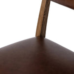 Both modern and traditional, toasted oak frames this high-back, armless dining chair. Finished with a rich brown top-grain leather, with hanging straps affixed to the back Amethyst Home provides interior design, new home construction design consulting, vintage area rugs, and lighting in the Nashville metro area.