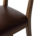 Both modern and traditional, toasted oak frames this high-back, armless dining chair. Finished with a rich brown top-grain leather, with hanging straps affixed to the back Amethyst Home provides interior design, new home construction design consulting, vintage area rugs, and lighting in the Salt Lake City metro area.