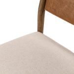 Mixed materials place a modern twist on the sling-back dining chair. A solid oak frame forms rounded dowel legs for a touch of traditionalism, with top-grain leather in a warm chestnut Amethyst Home provides interior design, new home construction design consulting, vintage area rugs, and lighting in the Charlotte metro area.