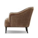 With elements of past eras at play, this updated Deco chair features a rounded back, sloped arms and a dramatic channel. The