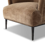 With elements of past eras at play, this updated Deco chair features a rounded back, sloped arms and a dramatic channel. The