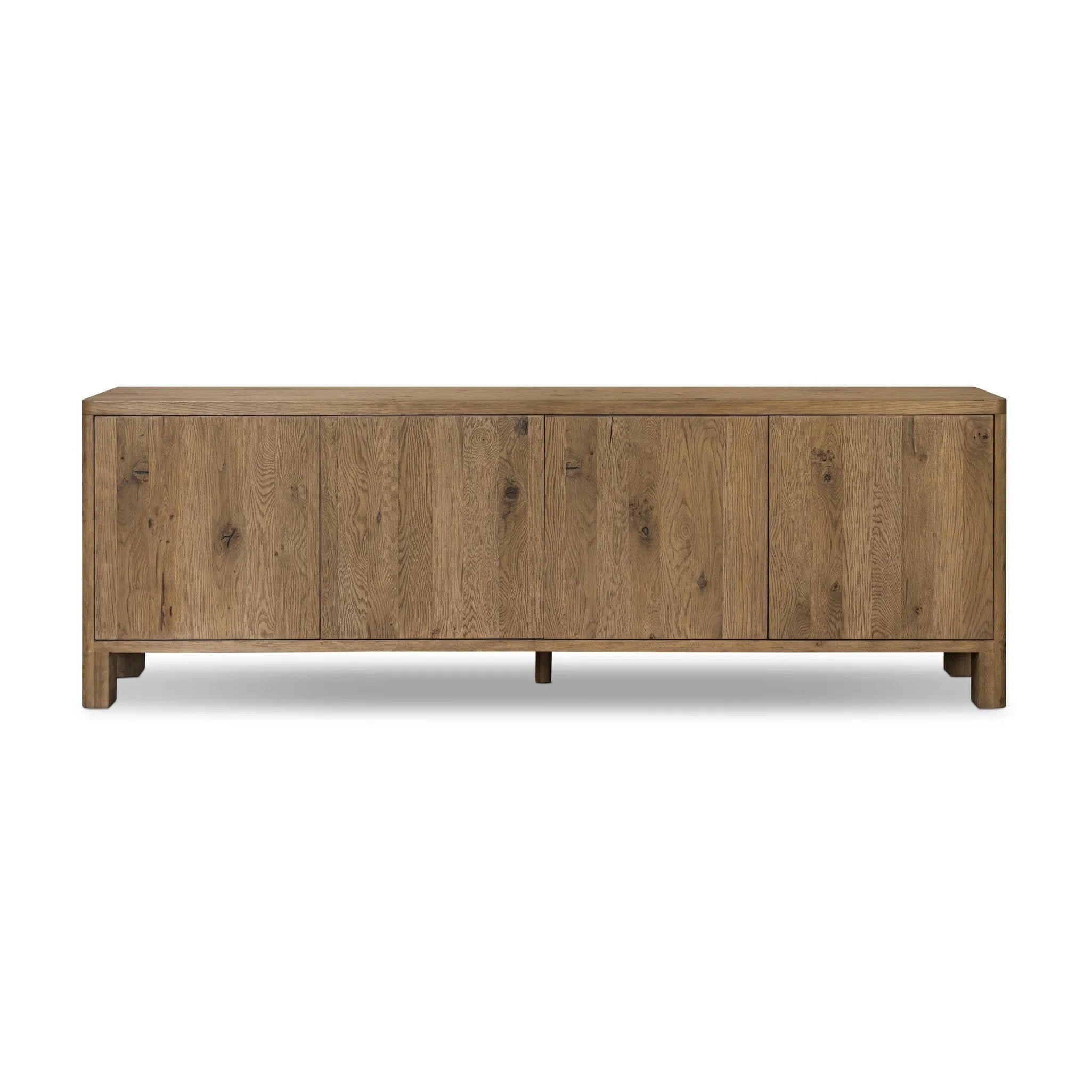 Featuring Noeline Resawn Worn Oak Sideboard by Four Hands at Amethyst Home. Made from resawn oak with a worn, natural finish, a long, streamlined sideboard offers ample storage space behind four push-latch doors. Subtly rounded corners add softness to otherwise clean lines, while knots and graining offer a naturally rich look. Dual rear cutouts for seamless cor. Amethyst Home provides interior design, new home construction design consulting, vintage area rugs, and lighting in the Tampa metro area.