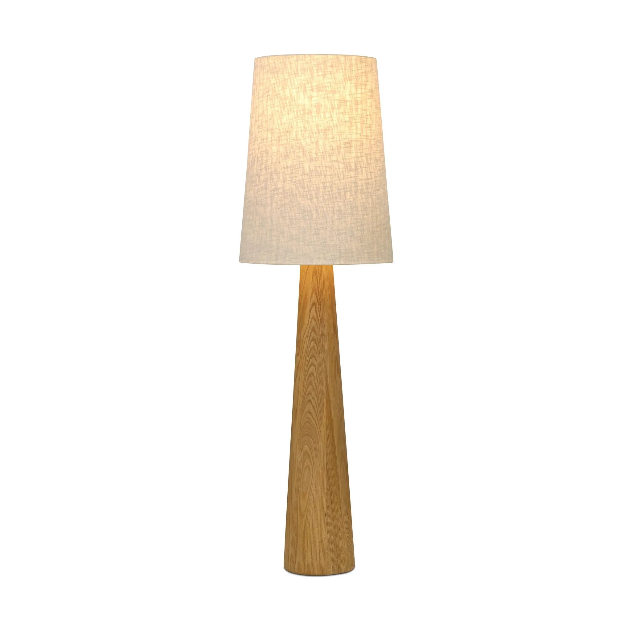 Modern minimal meets traditional. A tapered wood floor lamp base is topped with a design-forward boucle linen shade Amethyst Home provides interior design, new home construction design consulting, vintage area rugs, and lighting in the Houston metro area.