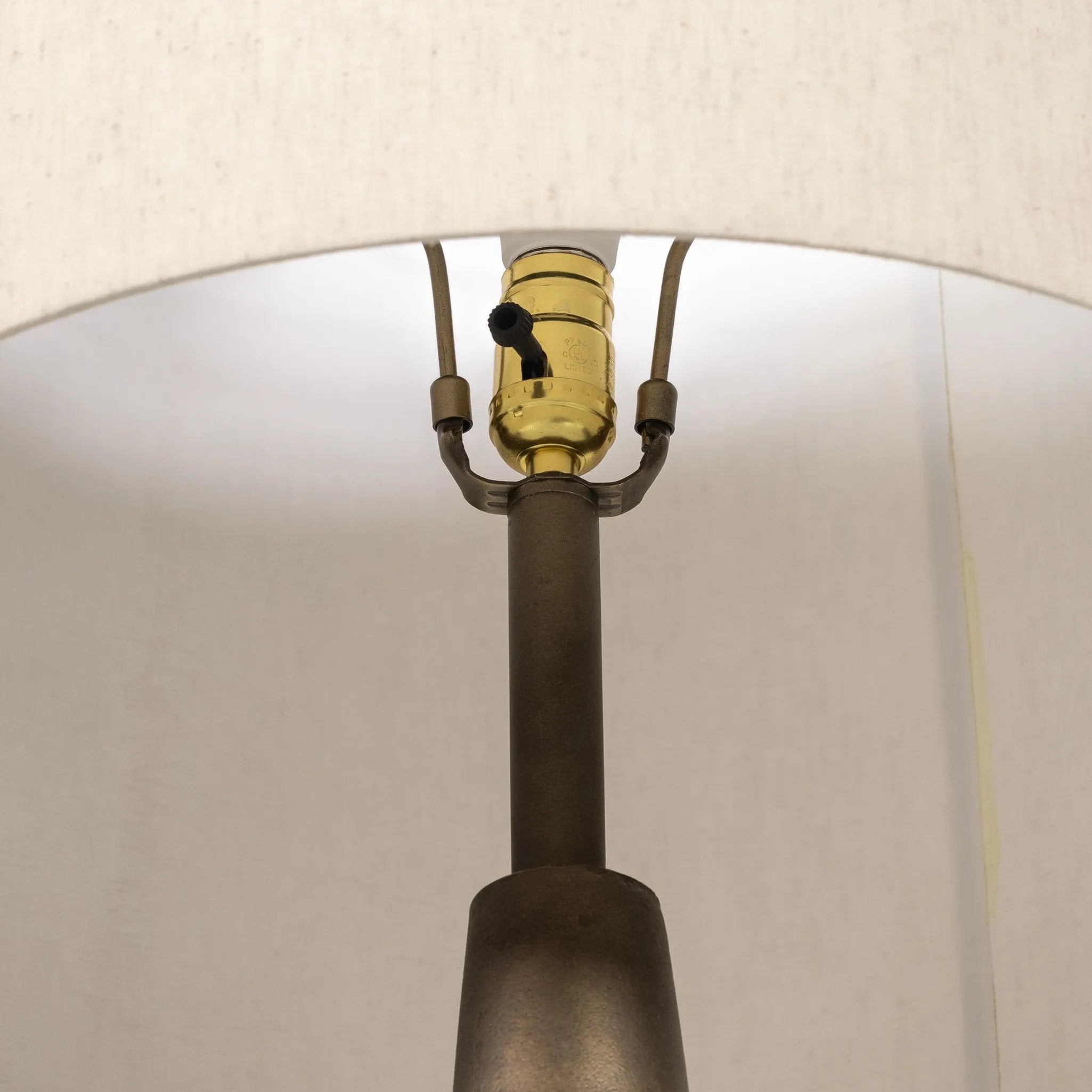 A striking silhouette. An antique brass finish highlights iron's gradual blending of hues for a distinctive ombre effect on this tapered metal base. Topped with a 100% cotton shade Amethyst Home provides interior design, new home construction design consulting, vintage area rugs, and lighting in the Miami metro area.