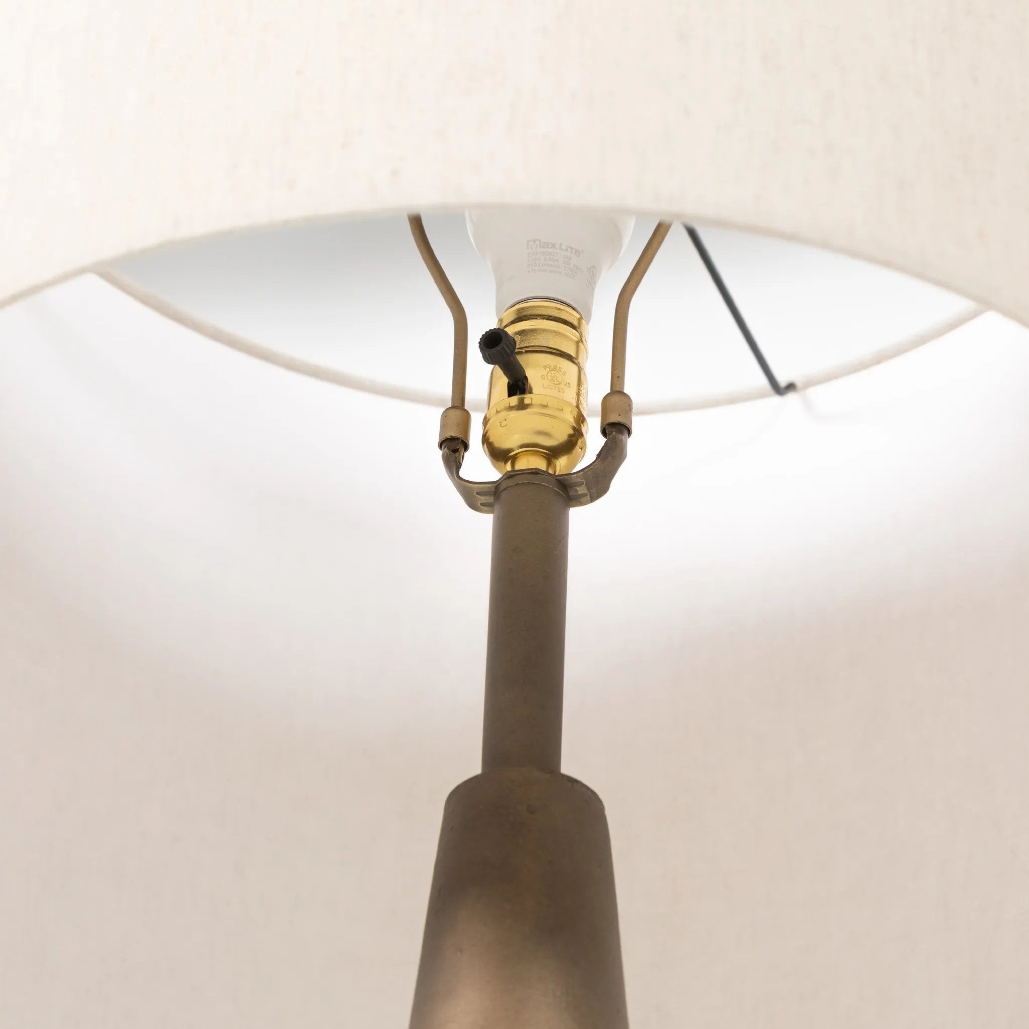 A striking silhouette. An antique brass finish highlights iron's gradual blending of hues for a distinctive ombre effect on this tapered metal base. Topped with a 100% cotton shade Amethyst Home provides interior design, new home construction design consulting, vintage area rugs, and lighting in the Scottsdale metro area.