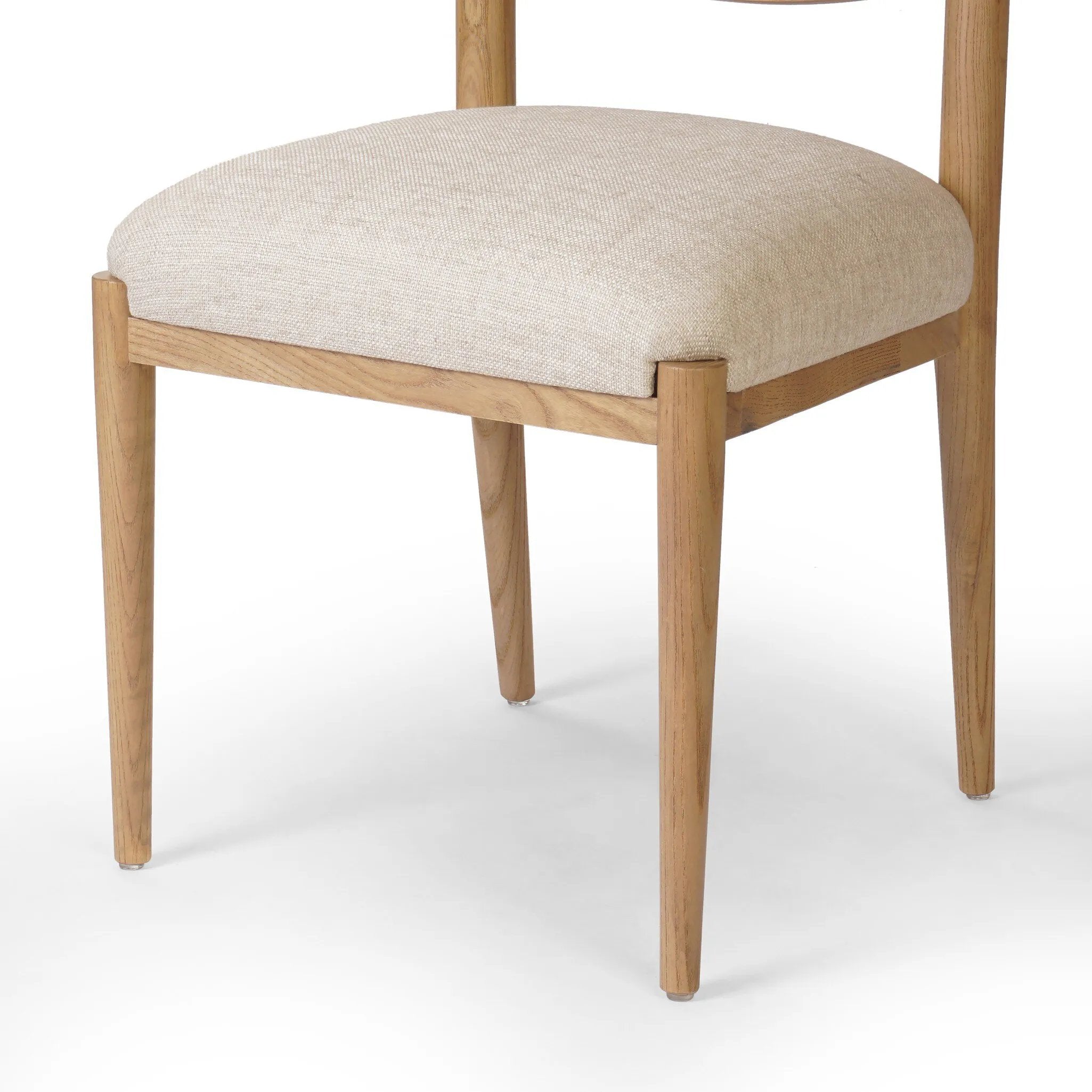 Featuring Piran Essence Natural Dining Chair by Four Hands at Amethyst Home. A celebration of simplicity. Natural nettlewood frames a comfortable linen-blend seat, while a subtle arc at the backrest's base softens clean, tapered lines. Performance fabrics are specially created to withstand spills, stains, high traffic and wear, ensuring long-term comfort an. Amethyst Home provides interior design, new home construction design consulting, vintage area rugs, and lighting in the San Diego metro area.