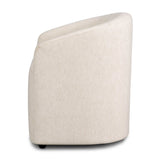 A fully upholstered barrel-style back dining chair creates a comfortable, cocoon-like sit. Slight scale perfect for smaller dining spaces Amethyst Home provides interior design, new home construction design consulting, vintage area rugs, and lighting in the Austin metro area.