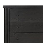 Create storage space in the bedroom with a five-drawer dresser of ebony-finished oak. Chunky dowel legs support a tall silhouette and overhang top, all finished out with simple gunmetal hardware Amethyst Home provides interior design, new home construction design consulting, vintage area rugs, and lighting in the Laguna Beach metro area.