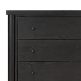 Create storage space in the bedroom with a five-drawer dresser of ebony-finished oak. Chunky dowel legs support a tall silhouette and overhang top, all finished out with simple gunmetal hardware Amethyst Home provides interior design, new home construction design consulting, vintage area rugs, and lighting in the Laguna Beach metro area.