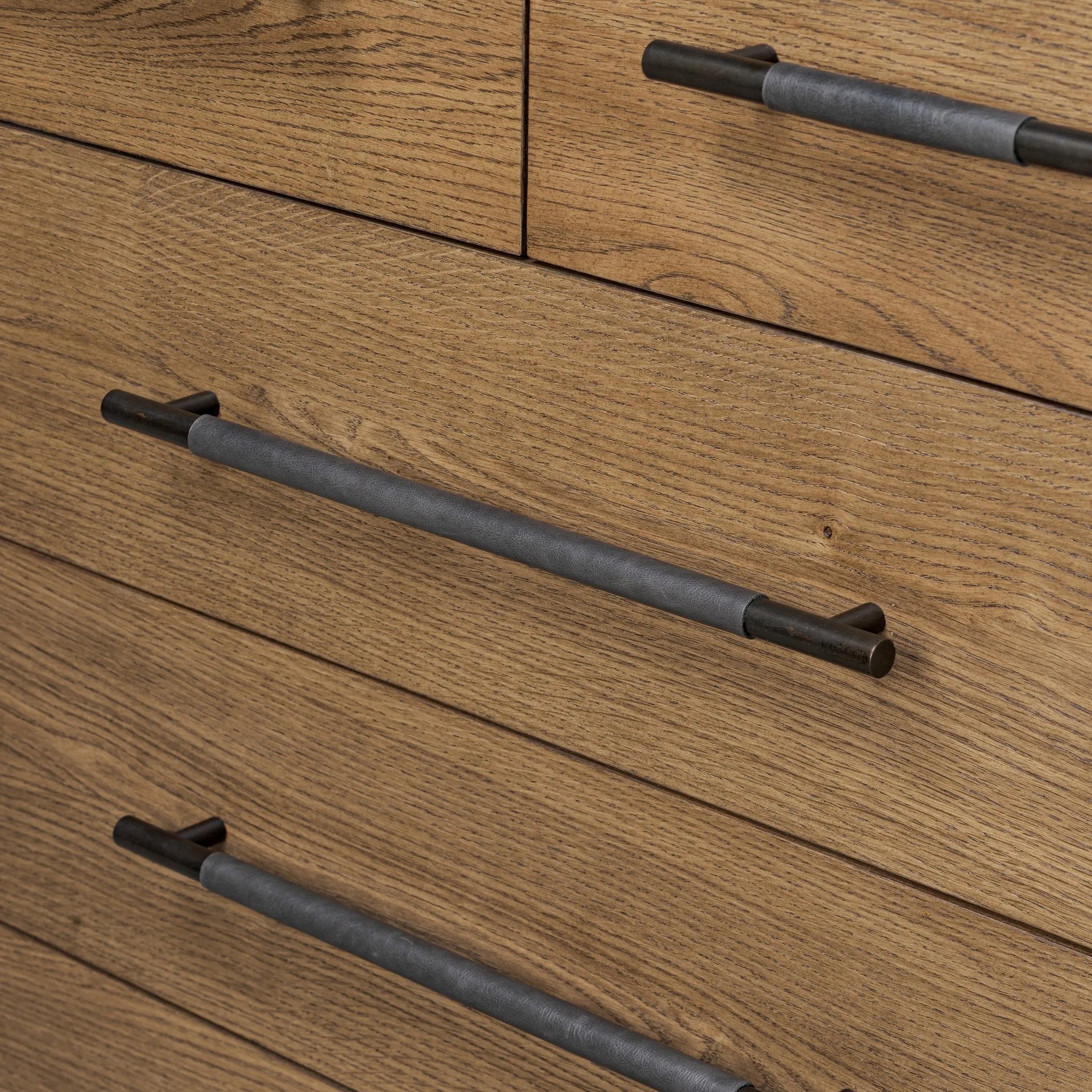 Amber-finished oak forms a clean silhouette for six spacious drawers with iron hardware wrapped in black top-grain leather. This item has been modified to comply with the STURDY Act. See a full list of modified products and data changes in the “STURDY Act” file in the Downloads section below Amethyst Home provides interior design, new home construction design consulting, vintage area rugs, and lighting in the Scottsdale metro area.