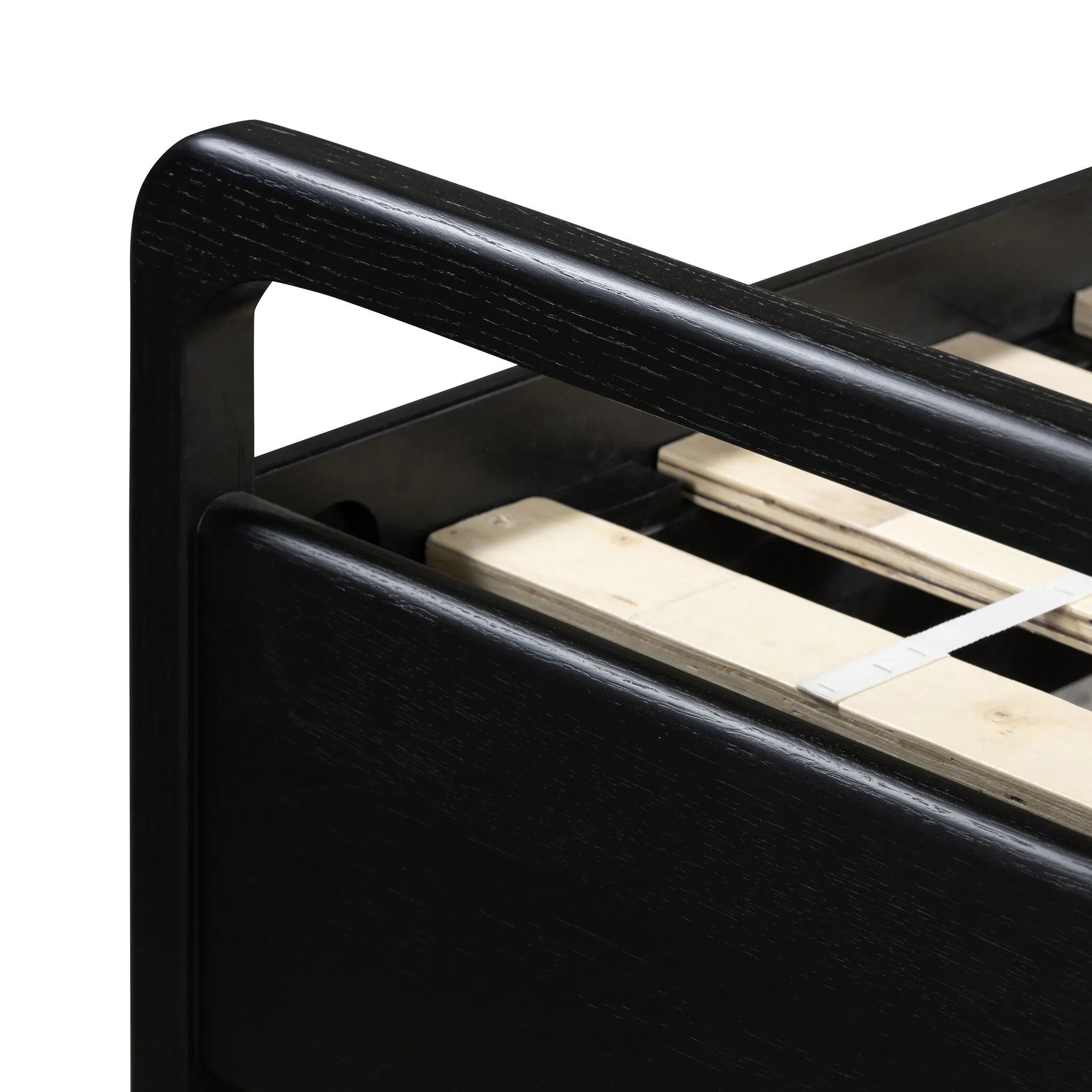 Ebony-finished oak frames a sling-style headboard made from top-grain leather, with subtly rounded edges and metal dowel detailing Amethyst Home provides interior design, new home construction design consulting, vintage area rugs, and lighting in the Boston metro area.