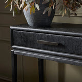 Featuring Rosenell Black Oak Veneer Console Table 60" by Four Hands at Amethyst Home. Elevate your living space or media room with a slim-profile console of black-finished oak. A smooth top pairs with two drawers covered with woven paper cord, while lower open shelving creates bonus storage and display options. The result: a dark, Scandinavian-inspired loo. Amethyst Home provides interior design, new home construction design consulting, vintage area rugs, and lighting in the Washington metro area.