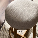 Featuring Staria Saxon Sand Swivel Stool by Four Hands at Amethyst Home. Perfectly sized for the counter, a 360-degree swivel stool pairs a warm oak frame with sand seating in a chunky basketweave. Tapered legs meet a crossed base ties it all together. Overall Dimensions: 18.25"w x 18.25"d x 27.50"h. Amethyst Home provides interior design, new home construction design consulting, vintage area rugs, and lighting in the Houston metro area.