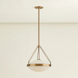 The Kade pendant updates a nostalgic shape with sleek, industrial metalwork and two large opal matte glass shades. Inspired by vintage elements, it features a striking suspension technique with three oversized loops connecting to the central housing above the fixture. The Patina Brass finish adds old-world finesse to the frame. Amethyst Home provides interior design, new home construction design consulting, vintage area rugs, and lighting in the Winter Garden metro area.