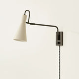 The Yvette plug-in sconce uses a modern lens to reimagine vintage design motifs. The geometry of the metalwork has been simpl