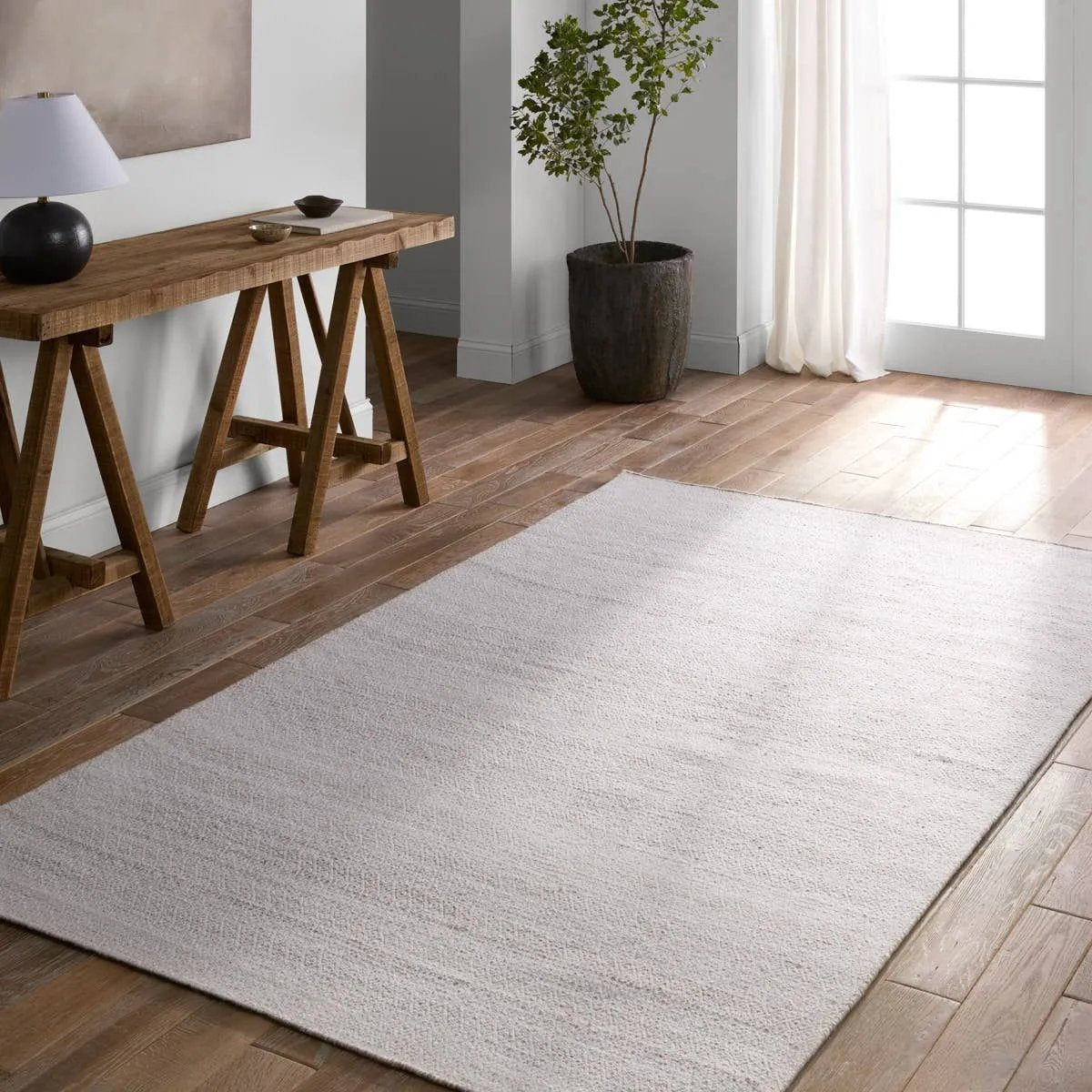 Featuring Almas Imogen Rug by Jaipur Living at Amethyst Home. Handwoven of weather-resistant PET, the Almas Imogen delights with contemporary colorways and designs. The Imogen design showcases a diamond trellis pattern in a colorway of gray and white. The variegated neutral hues provide a subtle distressed look that wears well over time. Crafted of recycled. Amethyst Home provides interior design, new home construction design consulting, vintage area rugs, and lighting in the San Diego metro area.