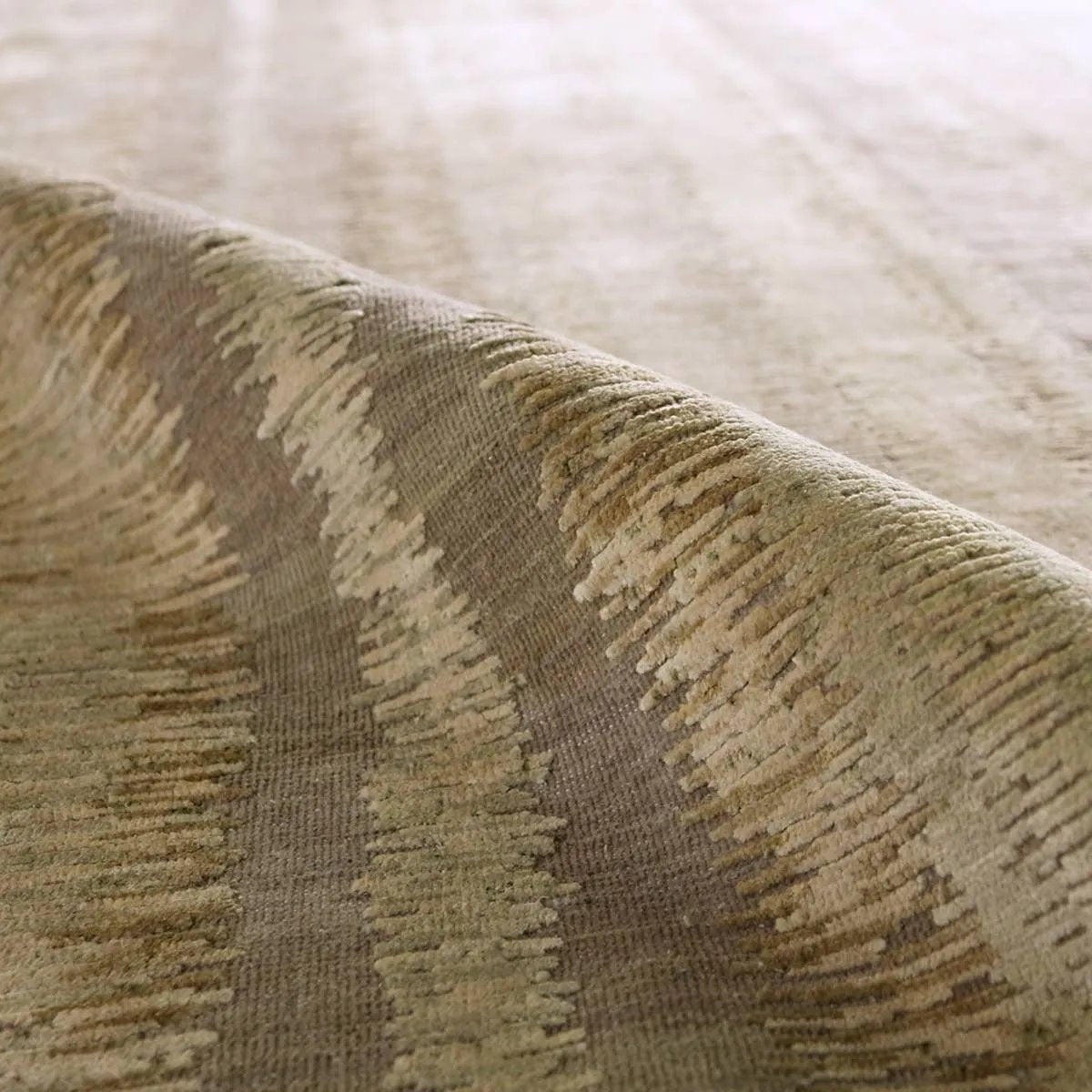 Featuring Jovian Hand-Knotted Rug by Jaipur Living at Amethyst Home. A contemporary interplay of cream and green comes to life in a striking abstract linear design. Crafted from a luxurious blend of viscose and silk, the Jovian design’s luminous sheen accentuates the depth and movement of its pattern. This handknotted piece exudes sophistication and exce. Amethyst Home provides interior design, new home construction design consulting, vintage area rugs, and lighting in the Laguna Beach metro area.