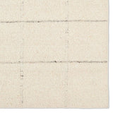 Featuring Leona Coart Rug by Jaipur Living at Amethyst Home. With its lofty, handmade loops, the Coart rug is an inviting, textural essential. Crafted of 100% undyed wool, its natural, relaxed, persona is met with a crisp, contemporary grid pattern.  An outstanding union of artistry and contemporary style, its physical approachability, monochromatic palett. Amethyst Home provides interior design, new home construction design consulting, vintage area rugs, and lighting in the Scottsdale metro area.