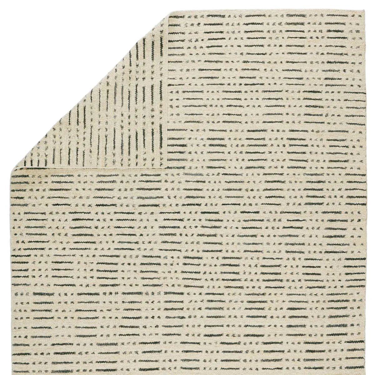Featuring Leona  Elver Rug by Jaipur Living at Amethyst Home. The texture-rich Leona Elver offers an assortment of updated kilim looks, re-invented with the on-trend shearling style and neutral, modern palettes. The handwoven Elver rug features a globally inspired, gray dot and ticking line pattern on a neutral tan base. This 100% wool accent piece delights i. Amethyst Home provides interior design, new home construction design consulting, vintage area rugs, and lighting in the Houston metro area.