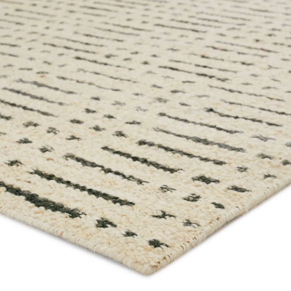 Featuring Leona  Elver Rug by Jaipur Living at Amethyst Home. The texture-rich Leona Elver offers an assortment of updated kilim looks, re-invented with the on-trend shearling style and neutral, modern palettes. The handwoven Elver rug features a globally inspired, gray dot and ticking line pattern on a neutral tan base. This 100% wool accent piece delights . Amethyst Home provides interior design, new home construction design consulting, vintage area rugs, and lighting in the Monterey metro area.