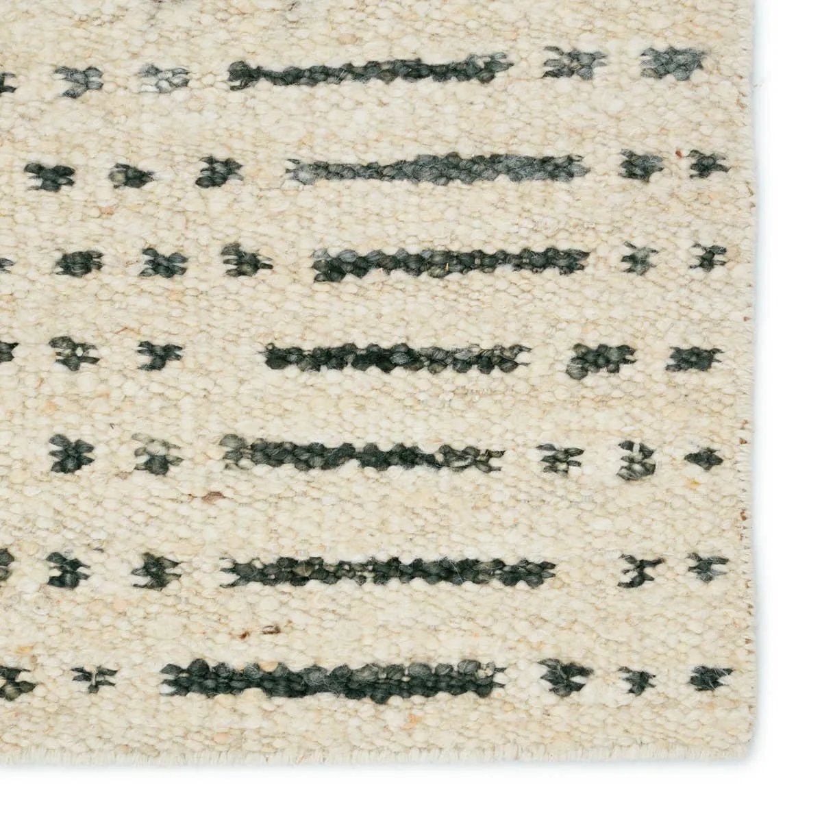 Featuring Leona  Elver Rug by Jaipur Living at Amethyst Home. The texture-rich Leona Elver offers an assortment of updated kilim looks, re-invented with the on-trend shearling style and neutral, modern palettes. The handwoven Elver rug features a globally inspired, gray dot and ticking line pattern on a neutral tan base. This 100% wool accent piece delights. Amethyst Home provides interior design, new home construction design consulting, vintage area rugs, and lighting in the San Diego metro area.