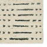 Featuring Leona  Elver Rug by Jaipur Living at Amethyst Home. The texture-rich Leona Elver offers an assortment of updated kilim looks, re-invented with the on-trend shearling style and neutral, modern palettes. The handwoven Elver rug features a globally inspired, gray dot and ticking line pattern on a neutral tan base. This 100% wool accent piece delights. Amethyst Home provides interior design, new home construction design consulting, vintage area rugs, and lighting in the San Diego metro area.