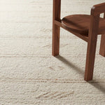 Featuring Leona  Essek Rug by Jaipur Living at Amethyst Home. The texture-rich Leona Essek offers an assortment of updated kilim looks, re-invented with the on-trend shearling style and neutral, modern palettes. The handwoven Essek rug features a globally inspired, light brown, stripe and tribal pattern on a neutral cream base. This 100% wool accent piece de. Amethyst Home provides interior design, new home construction design consulting, vintage area rugs, and lighting in the Portland metro area.