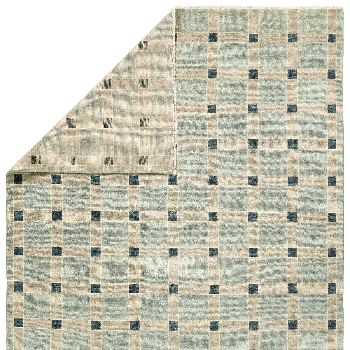 Featuring Quinlan Hand-Knotted Rug by Jaipur Living at Amethyst Home. The Quinlan design reinvents timeless geometric patterns, fusing classic charm with a modern edge. Soft beige tones, punctuated by a blue accent, elevate any mid-century modern space. Handcrafted from naturally stain-resistant wool, this rug handles medium-traffic areas, kids, and pets with. Amethyst Home provides interior design, new home construction design consulting, vintage area rugs, and lighting in the Seattle metro area.