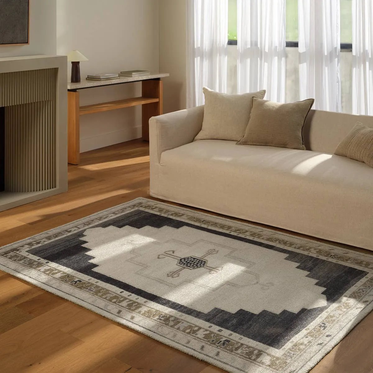 Featuring Stellar Rug by Jaipur Living at Amethyst Home. The Stellar design merges timeless tradition with a vintage-inspired aesthetic. Featuring a striking central medallion, this rug is set against an elegant beige and black backdrop, accented by rich green detailing. Its classic pattern, paired with a gently distressed finish, creates an heirloom quali. Amethyst Home provides interior design, new home construction design consulting, vintage area rugs, and lighting in the Alpharetta metro area.