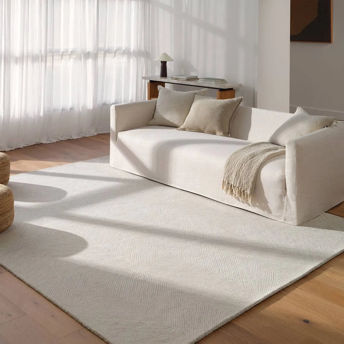 Featuring Tulsi Rug by Jaipur Living at Amethyst Home. The handtufted Labyrinth Collection features abstract designs crafted from plush wool with a cut-and-looped pile, creating a rich, tactile texture. The Tulsi design showcases a bold, geometric pattern with modern Brutalist influence in varying shades of gray and taupe, adding depth and sophistication. Amethyst Home provides interior design, new home construction design consulting, vintage area rugs, and lighting in the Laguna Beach metro area.