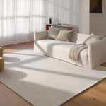 Featuring Tulsi Rug by Jaipur Living at Amethyst Home. The handtufted Labyrinth Collection features abstract designs crafted from plush wool with a cut-and-looped pile, creating a rich, tactile texture. The Tulsi design showcases a bold, geometric pattern with modern Brutalist influence in varying shades of gray and taupe, adding depth and sophistication. Amethyst Home provides interior design, new home construction design consulting, vintage area rugs, and lighting in the Laguna Beach metro area.