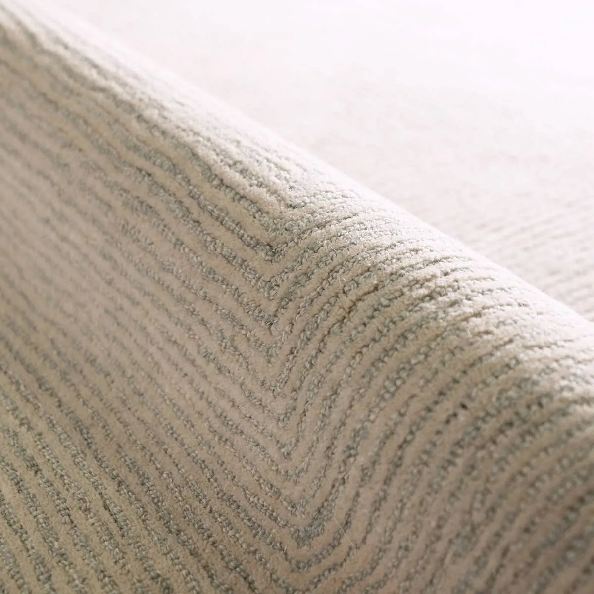 Featuring Tulsi Rug by Jaipur Living at Amethyst Home. The handtufted Labyrinth Collection features abstract designs crafted from plush wool with a cut-and-looped pile, creating a rich, tactile texture. The Tulsi design showcases a bold, geometric pattern with modern Brutalist influence in varying shades of gray and taupe, adding depth and sophistication wi. Amethyst Home provides interior design, new home construction design consulting, vintage area rugs, and lighting in the Park City metro area.