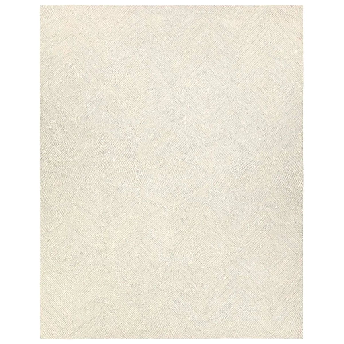 Featuring Tulsi Rug by Jaipur Living at Amethyst Home. The handtufted Labyrinth Collection features abstract designs crafted from plush wool with a cut-and-looped pile, creating a rich, tactile texture. The Tulsi design showcases a bold, geometric pattern with modern Brutalist influence in varying shades of gray and taupe, adding depth and sophisticati. Amethyst Home provides interior design, new home construction design consulting, vintage area rugs, and lighting in the Salt Lake City metro area.